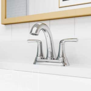 Chrome two-handle bathroom faucet with curved spout on a white vanity