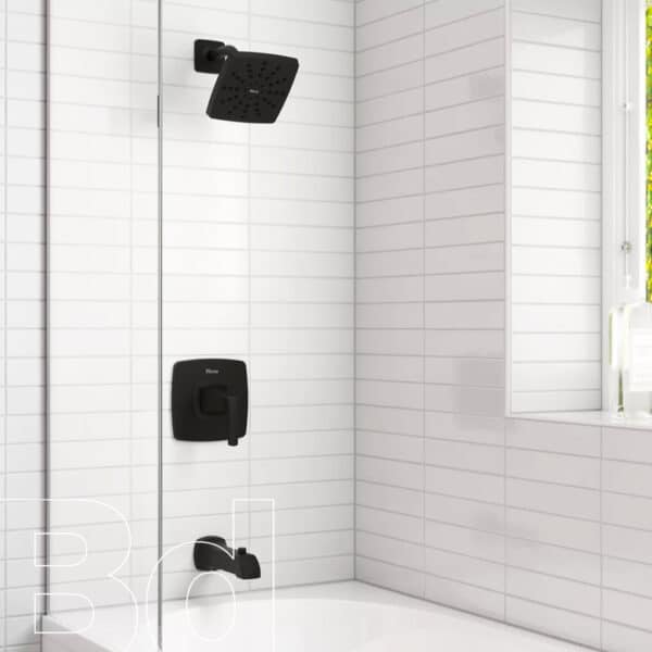Black square rainfall shower head and matching dark faucet fixtures mounted on white-tiled shower wall beside a tub.