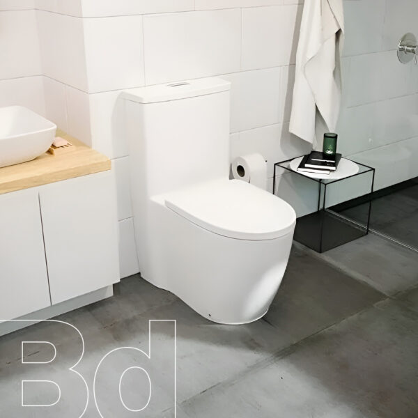 Contemporary bathroom with a white one-piece toilet, a wooden vanity with a white vessel sink, and a black metal side table holding a green bottle and a notebook beside a towel hanging on the wall.